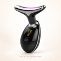 A black neck and face EMS massager with a curved T-shaped head, glossy finish, and a digital display showing settings, set against a light beige background.
