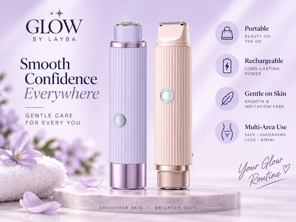 Two handheld beauty devices from Glow by Layba are displayed on a marble pedestal against a soft lavender background. The left device is lavender with a metallic lavender base, and the right device is champagne gold with a metallic gold base.